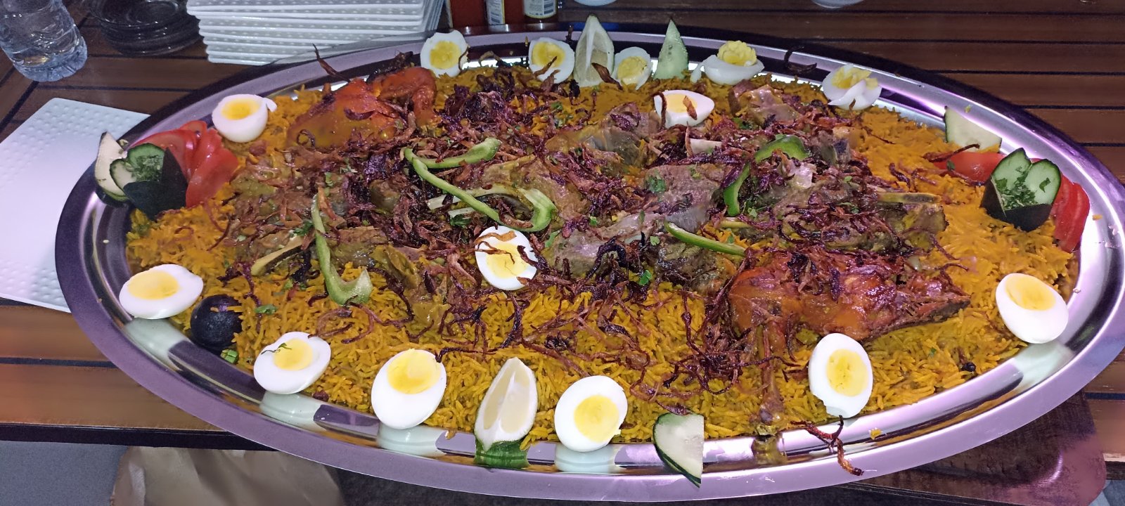 The Mafttah - a whole roasted lamb feast over saffron rice, ringed with boiled eggs