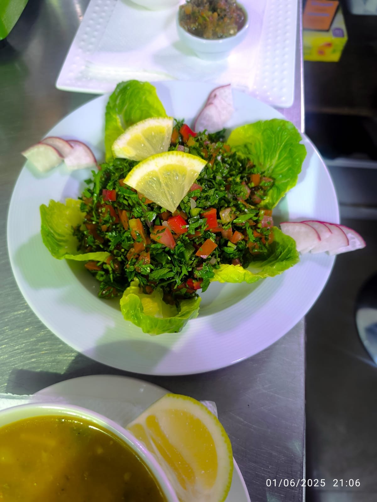 Fresh tabbouleh salad with lemon wedges