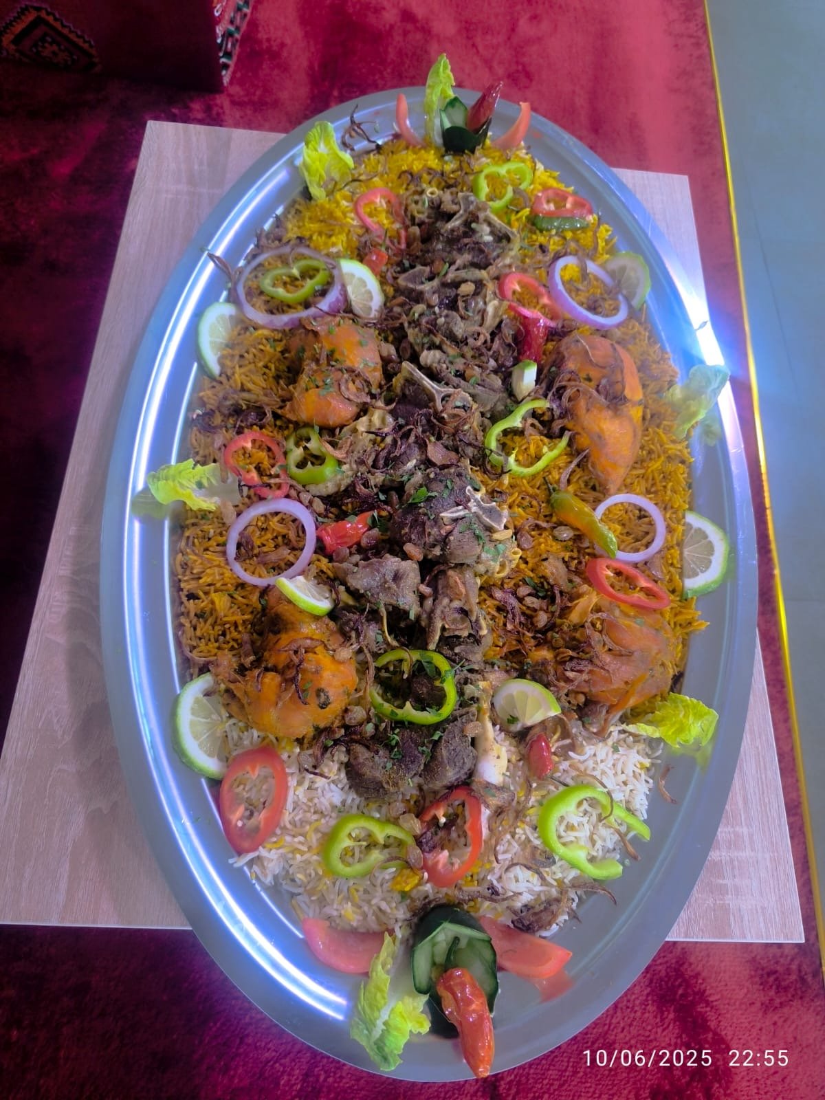 Mixed lamb and chicken feast platter over saffron and white rice, set for a festive occasion