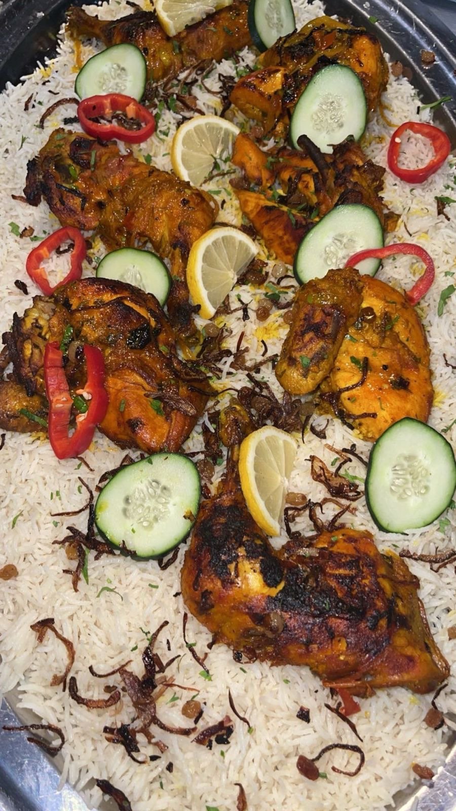 Chicken and lamb mandi over white rice with cucumber, lemon and chili