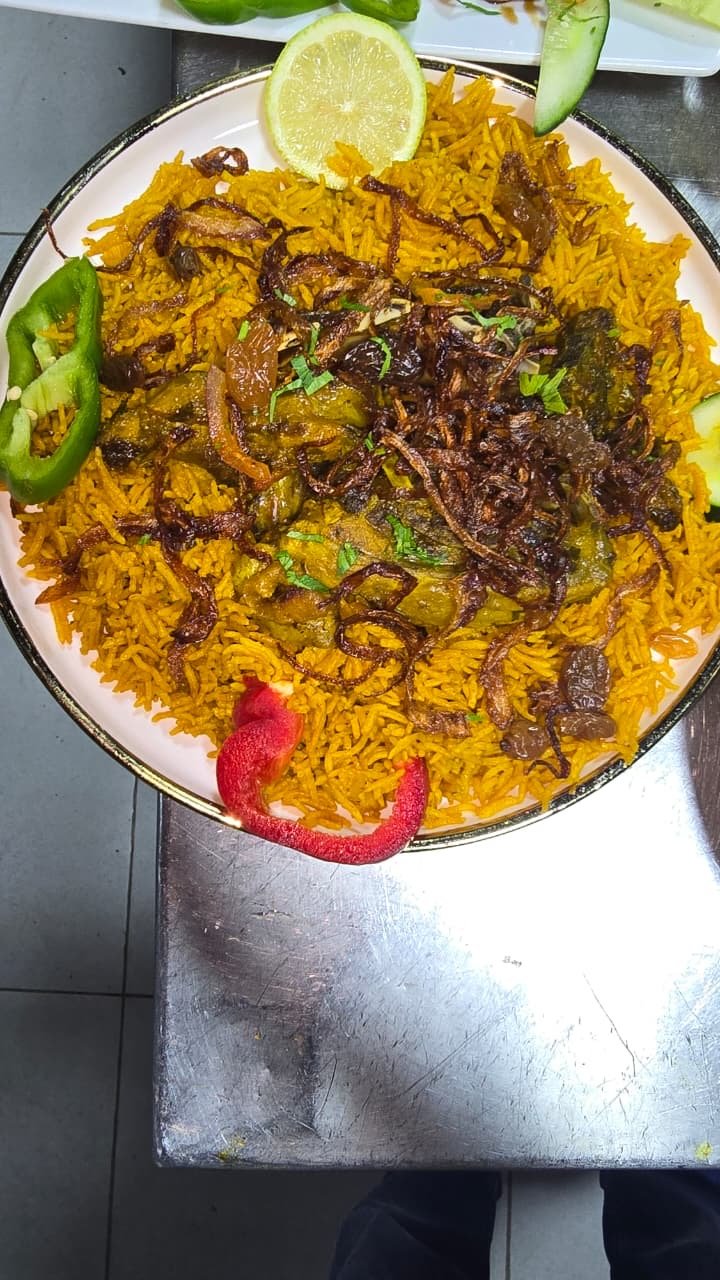 Kabsa rice with raisins, fried onions and pepper garnish