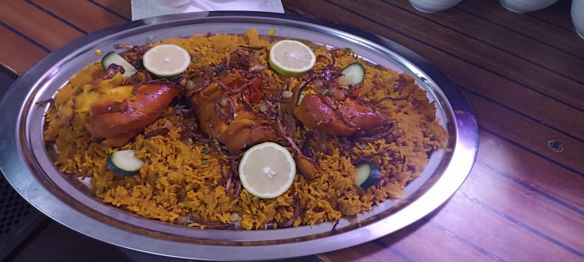 Chicken quarters over saffron rice with lemon